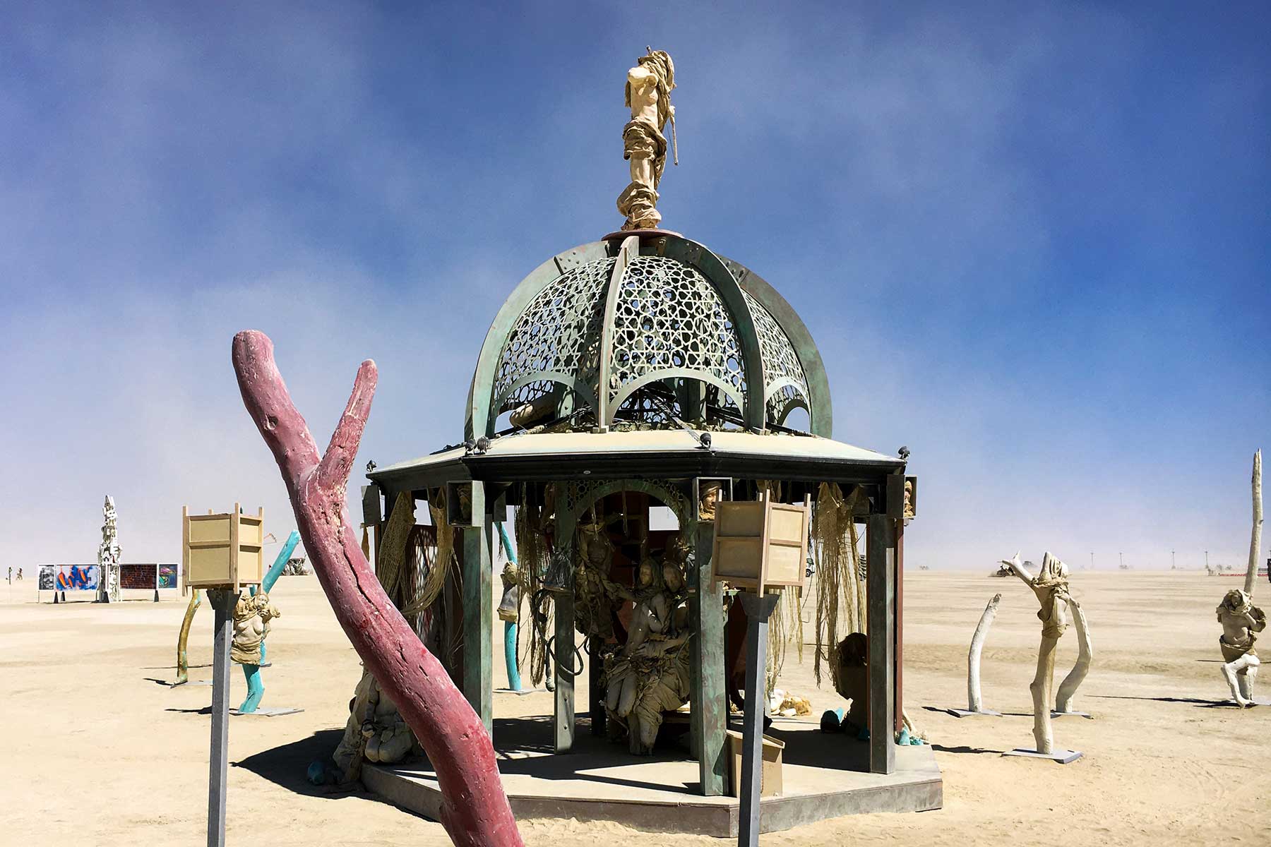 The domed pavilion of Secretly Abandoned Spaces, with a pink branch sculpture in the foreground